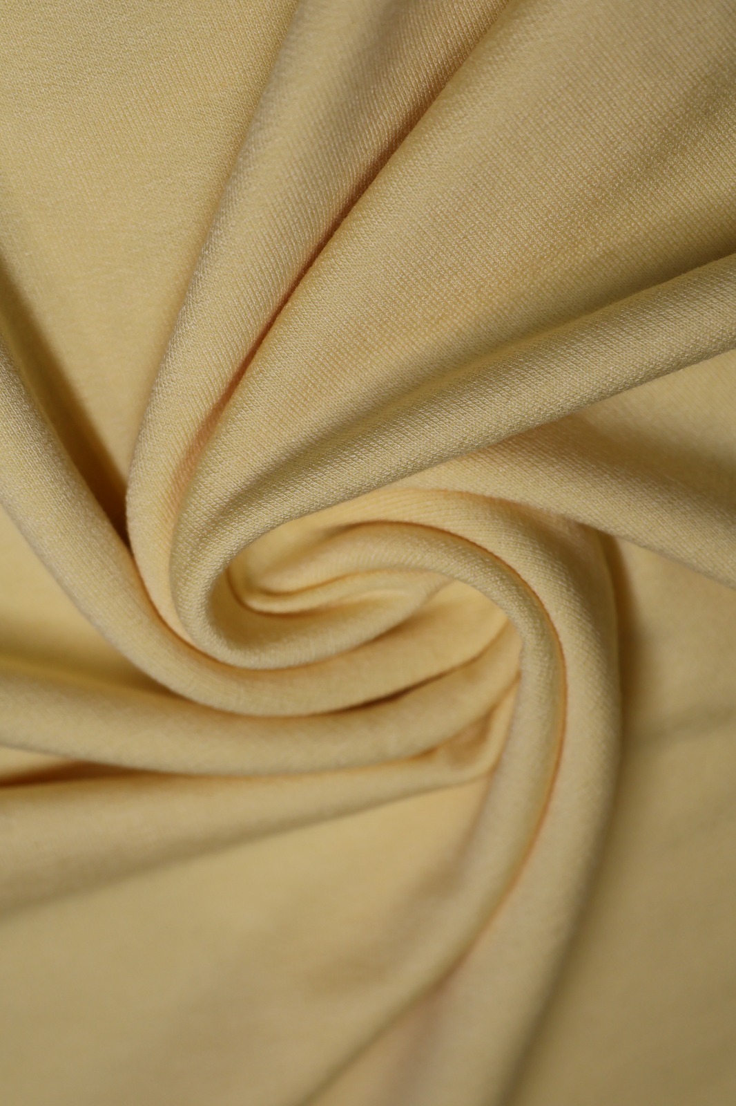Tecido amarelo Incotex com dobras em espiral